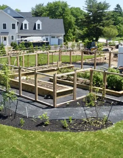 large raised bed garden with detached fence