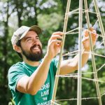 gardener working on bamboo trellis