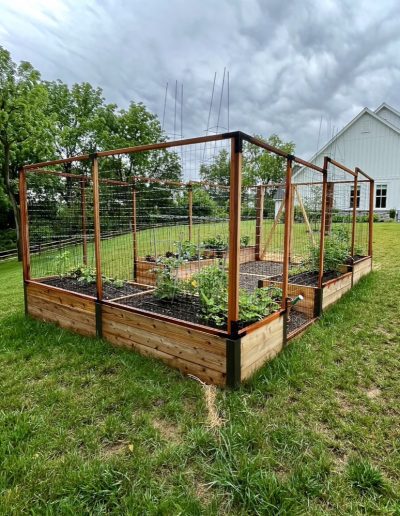 Raised bed garden with fence built on slope