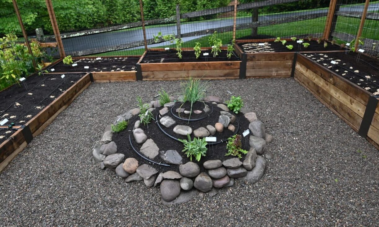 Photo of terraced raised bed garden with central herb spiral