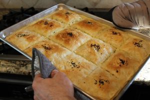 Photo of baked dish being pulled from oven