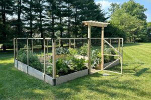 G-shaped raised bed garden in a sloped landscape