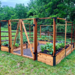 A photo of a u-shaped garden with a double gate and tiered raised beds