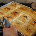 Photo of baked dish being pulled from oven